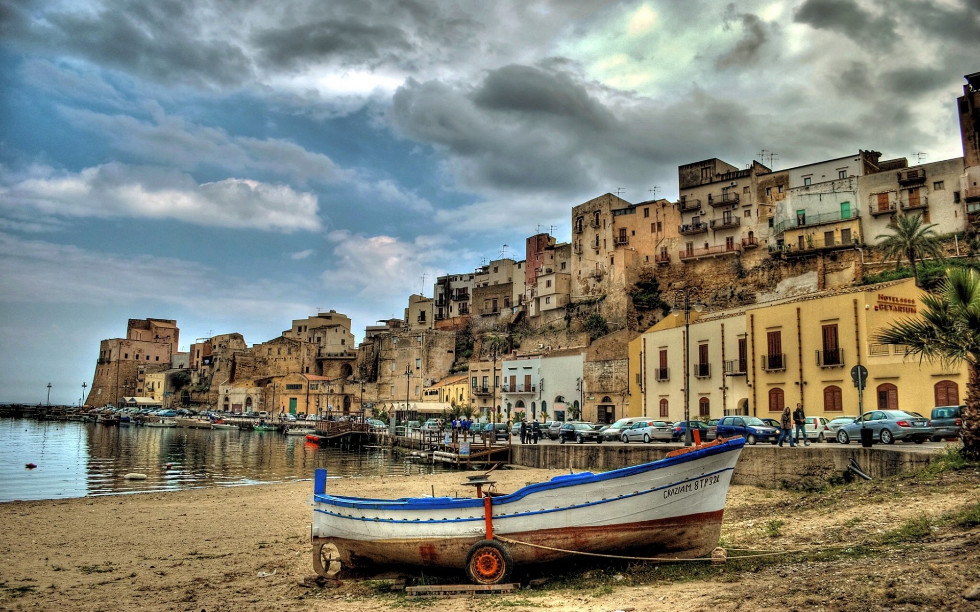 castellammare del golfo sicily italy harbor boat embankment buildings machinery car