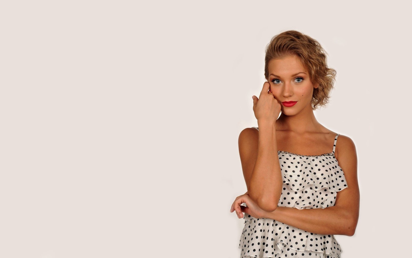 Kristina Asmus in a white polka dot dress