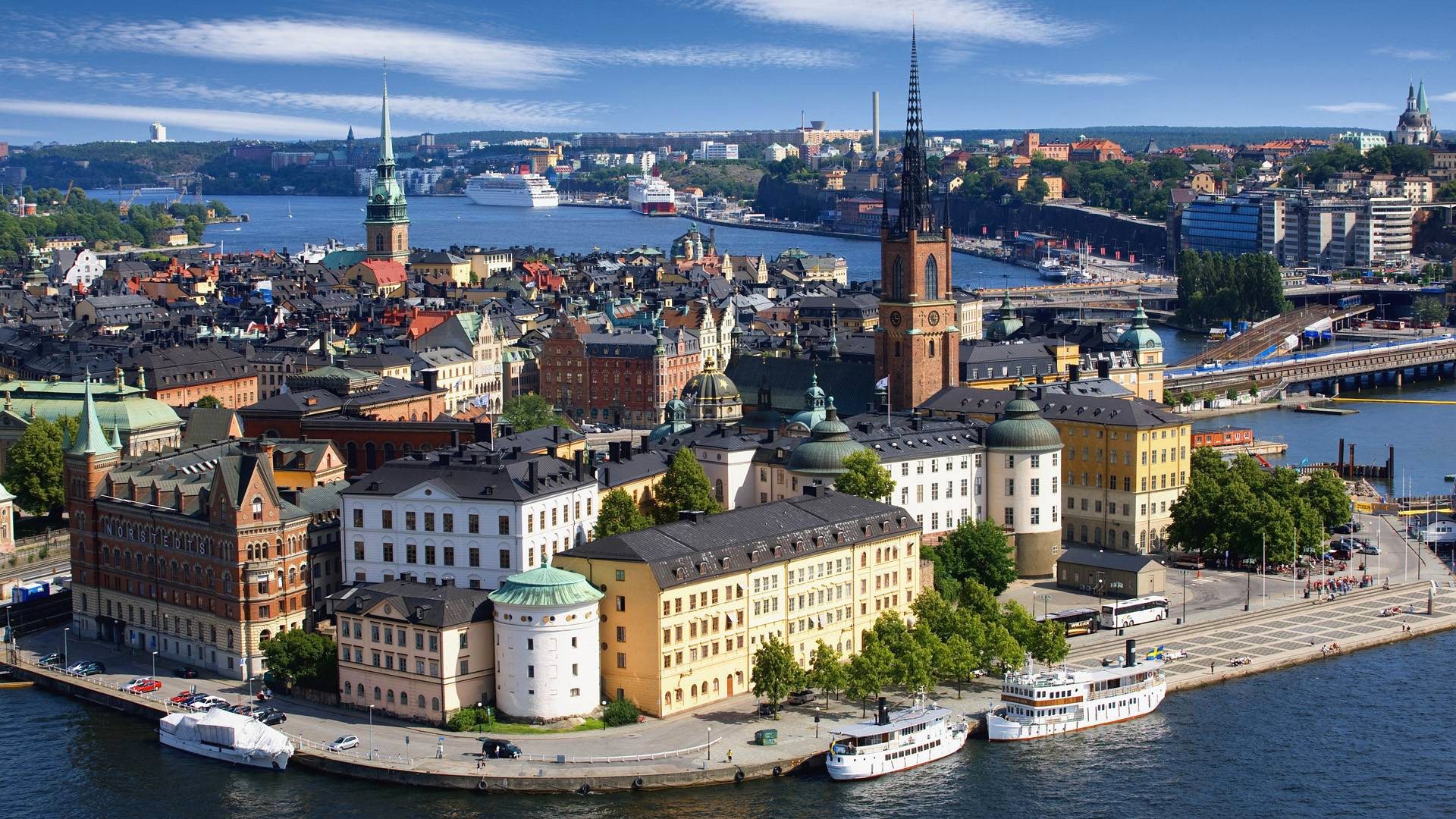 scandinavia sweden stockholm riddarholmen church river sea liner ship the port house tower spire sky clouds bridge