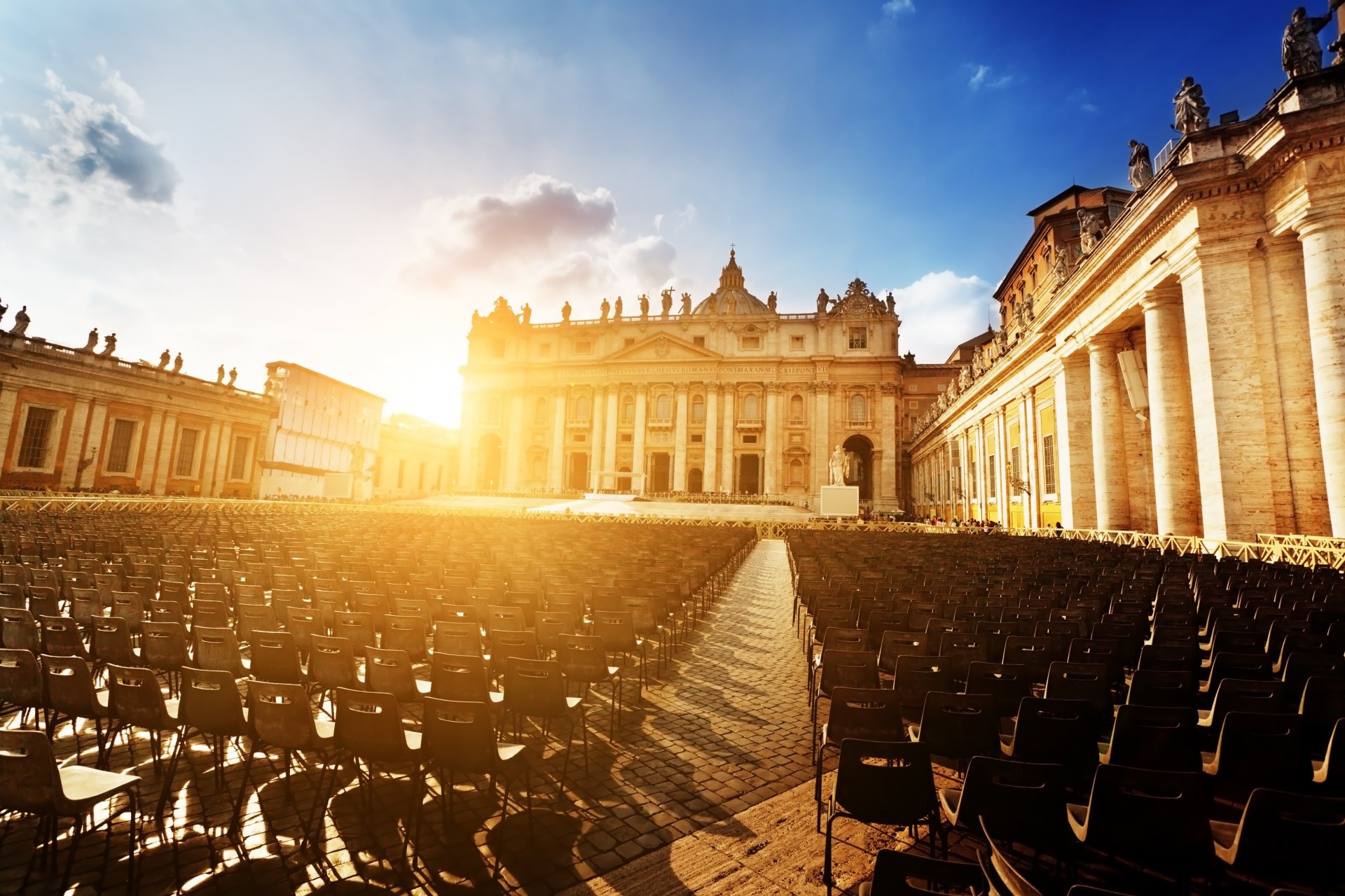 basilica di san pietro st. peter's basilica cathedral saint peter's square piazza san pietro vatican rome italy vatican city town square sunset sun chairs people