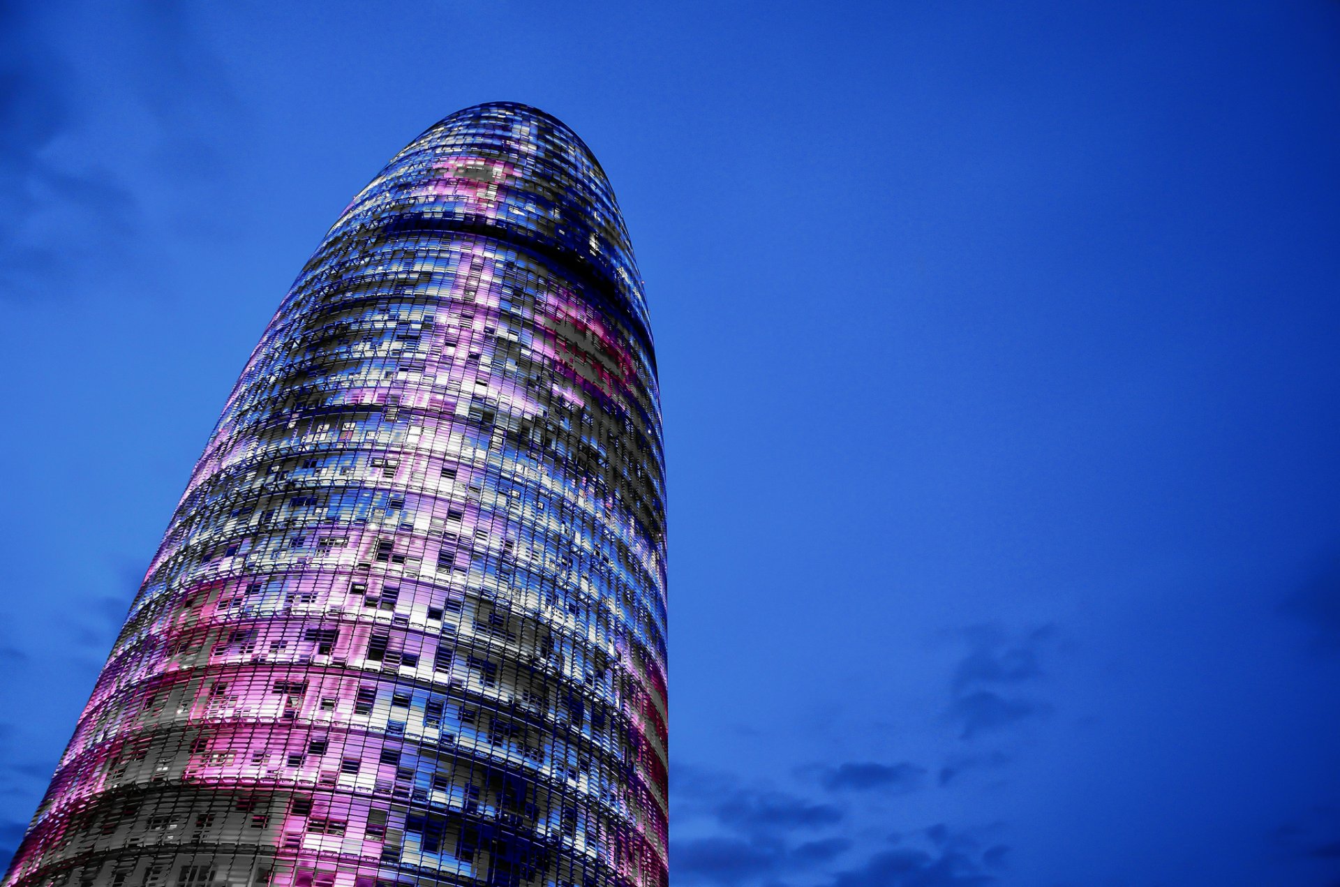 spain catalonia barcelona torre agbar tower skyscraper architecture construction night blue sky clouds