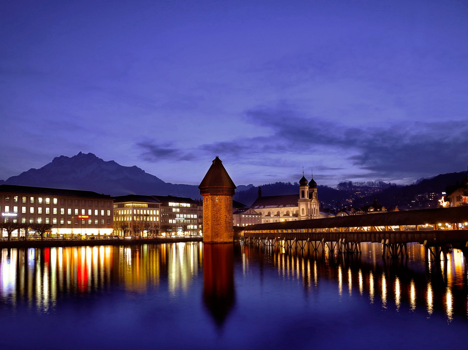 switzerland lucerne night twilight blue sky buildings temple light lights mountain bridge embankment river water surface of reflection