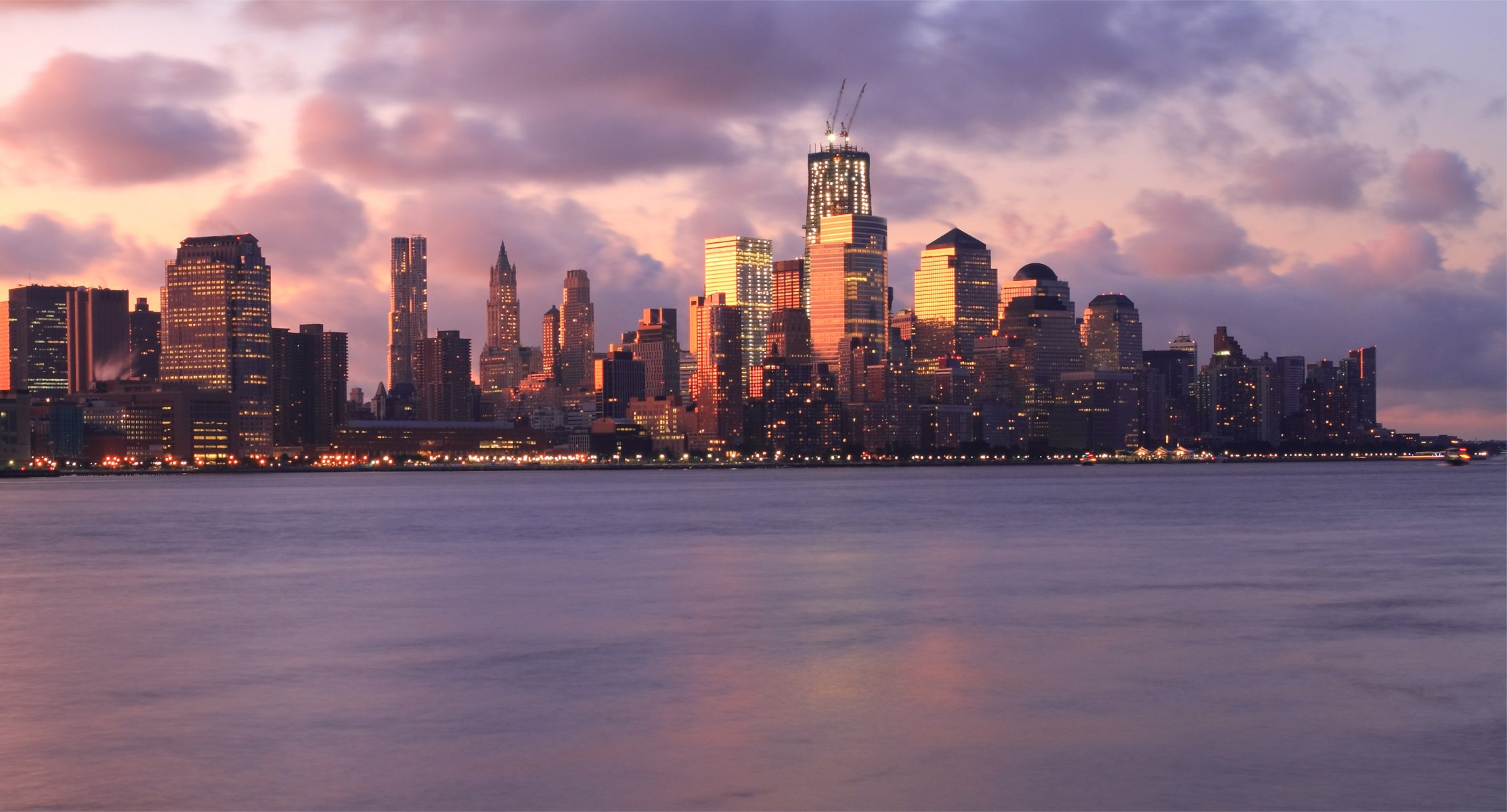 usa new york united states metropolis buildings skyscraper light lights river night pink sunset sky clouds