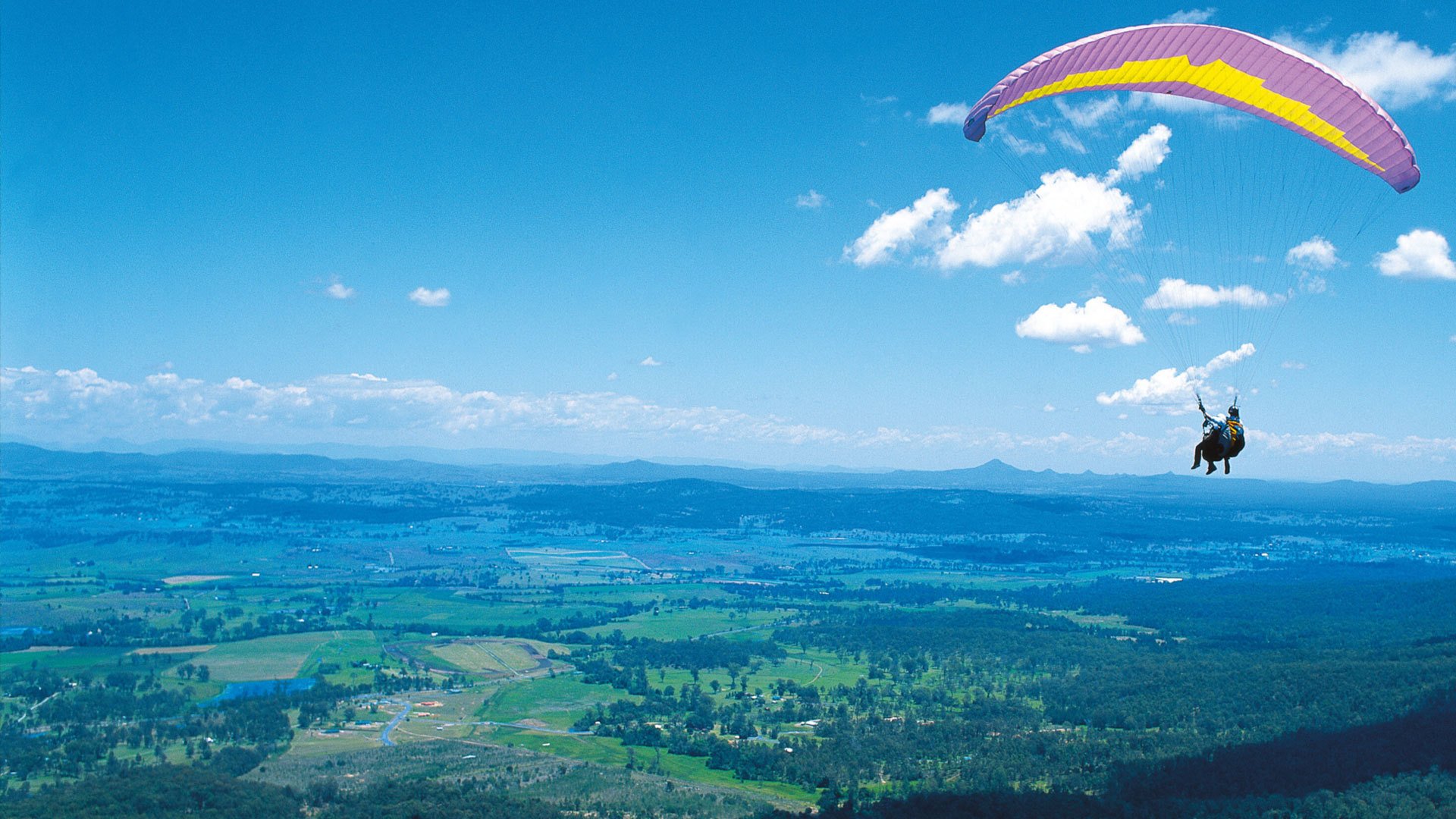 paragliding man flight mountain sky clouds land height