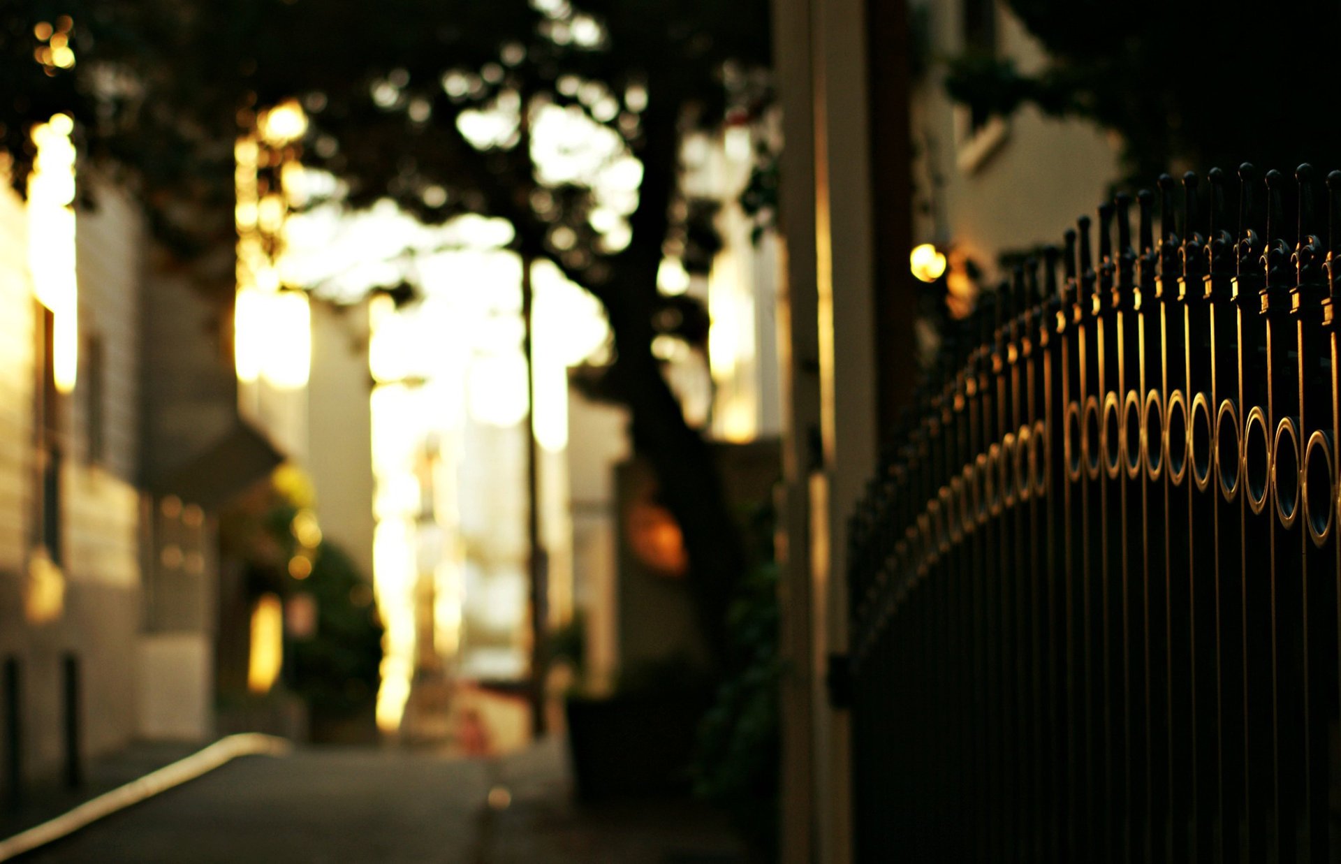 An iron fence closes the entrance to the courtyard