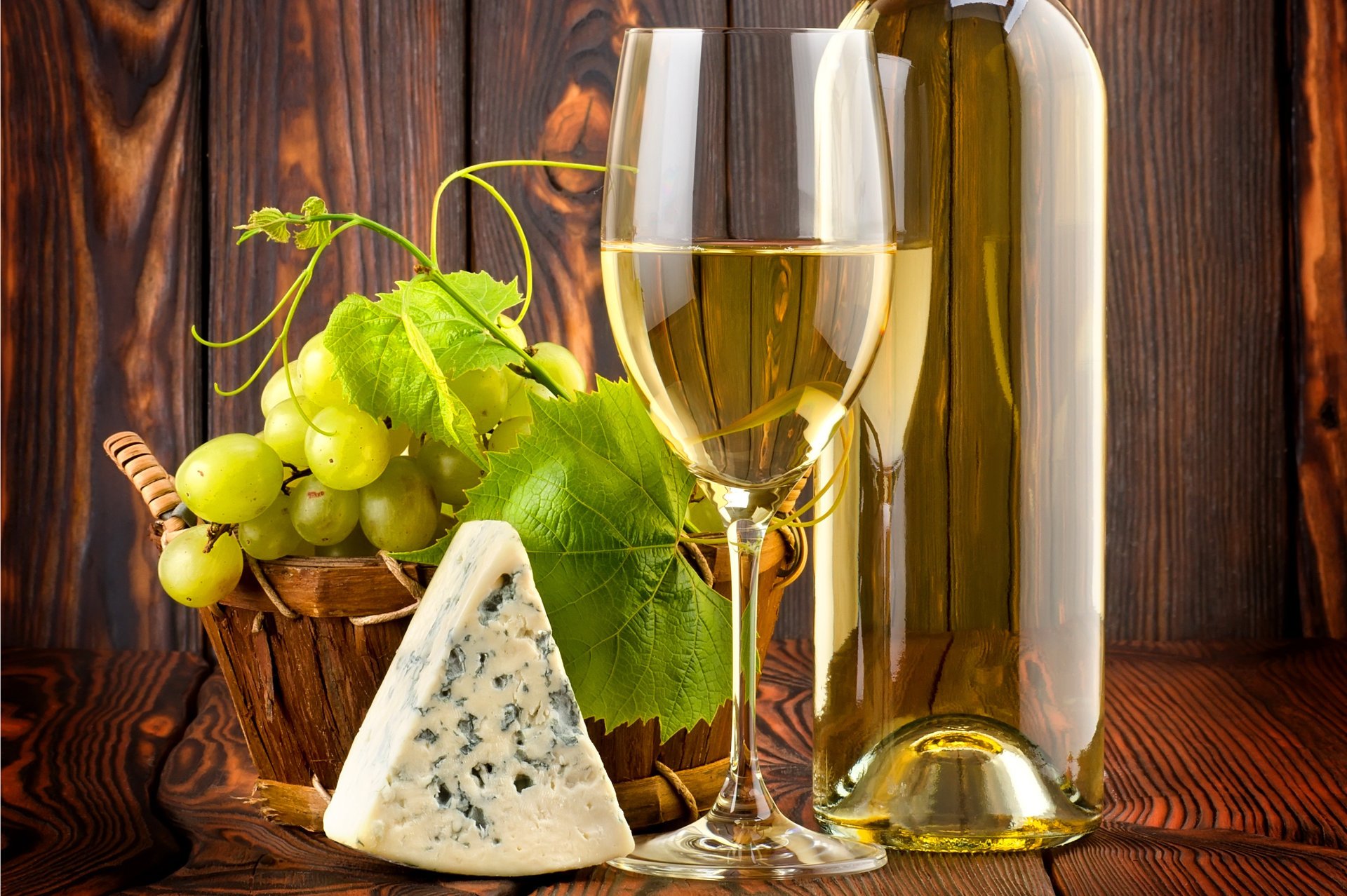 Still life with wine, grapes and cheese with blue mold