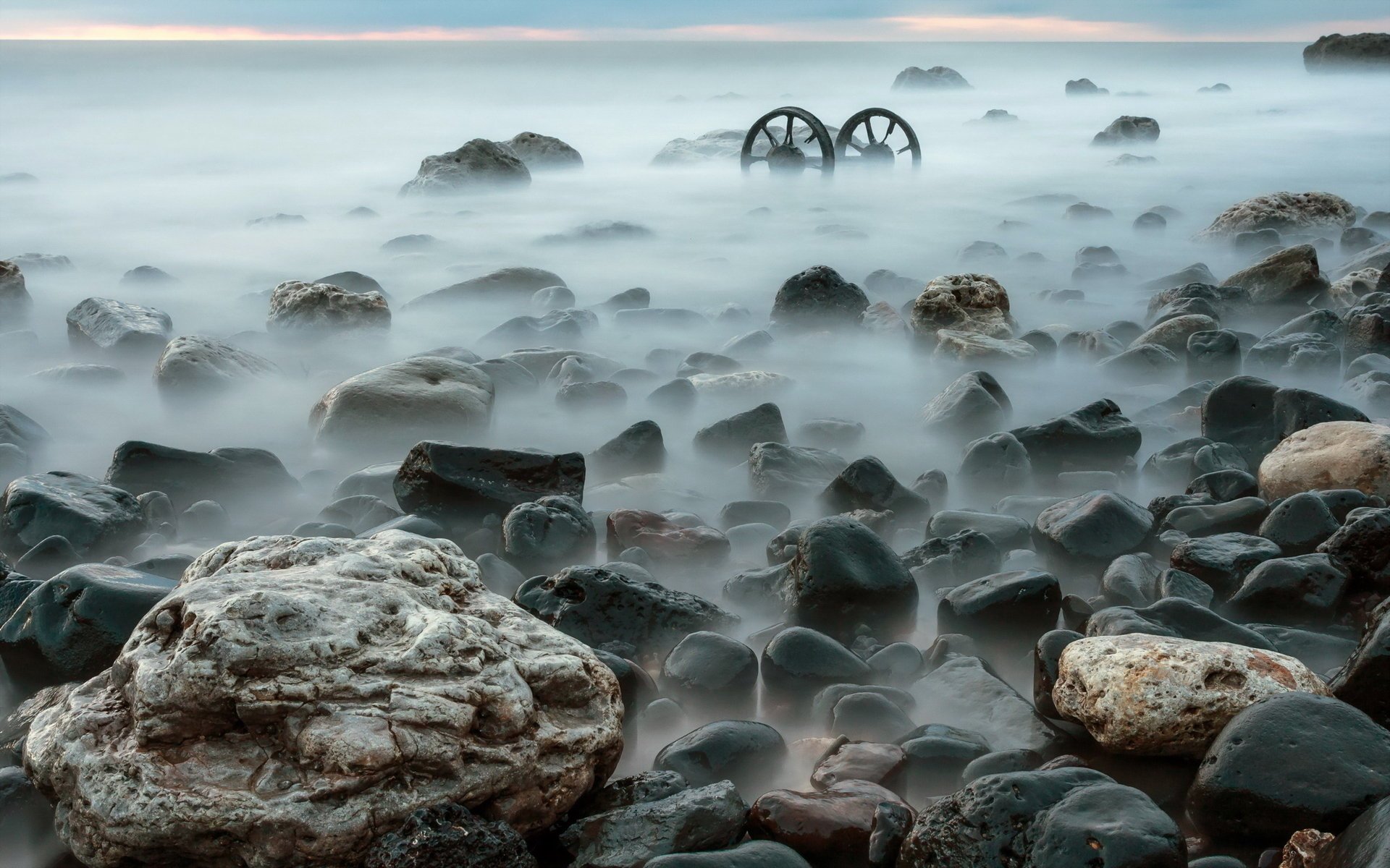 Seashore with rocks in the fog