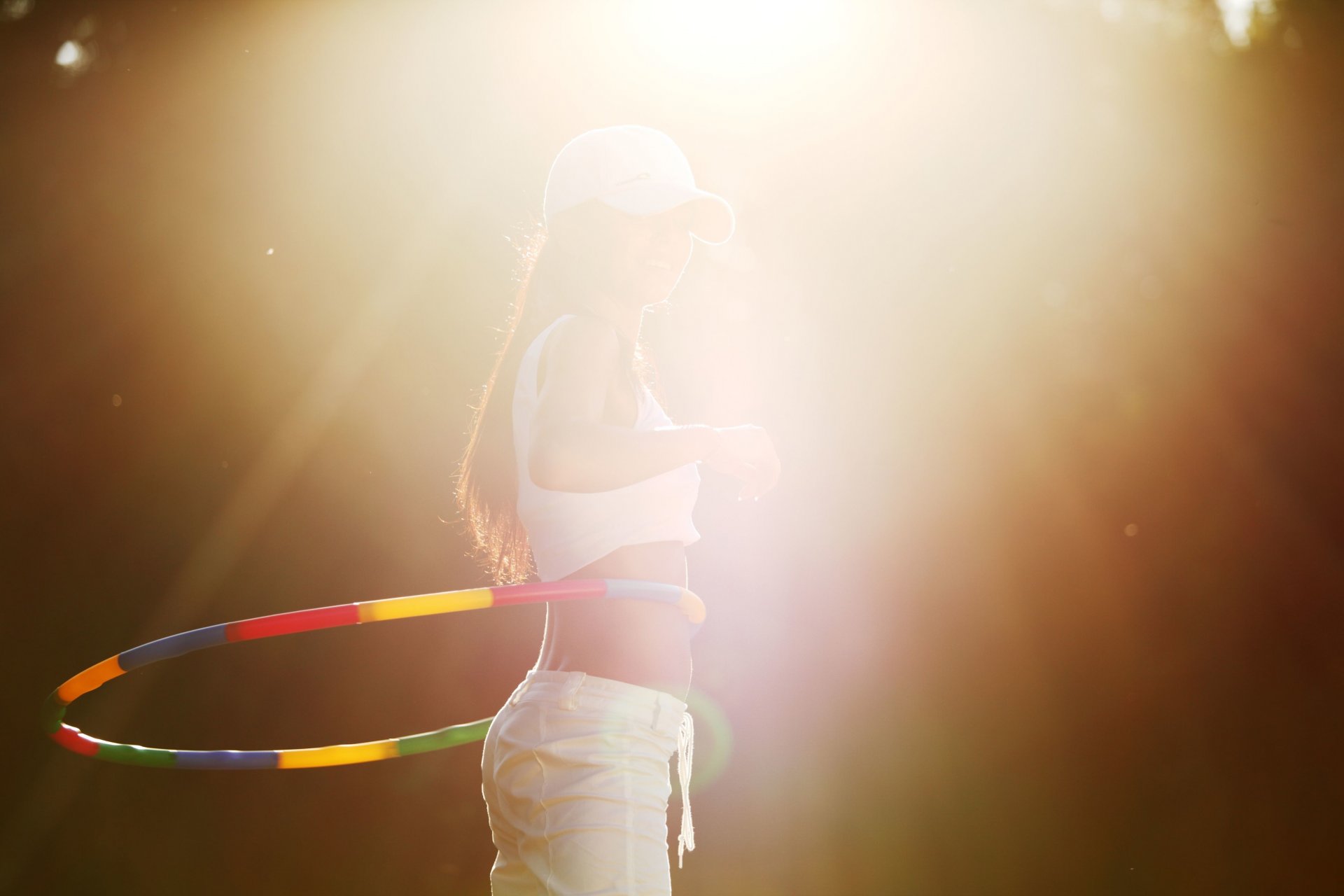 sports girl hoop hulahup figure motion rotation activity cap sun rays background wallpaper widescreen full screen hd wallpapers