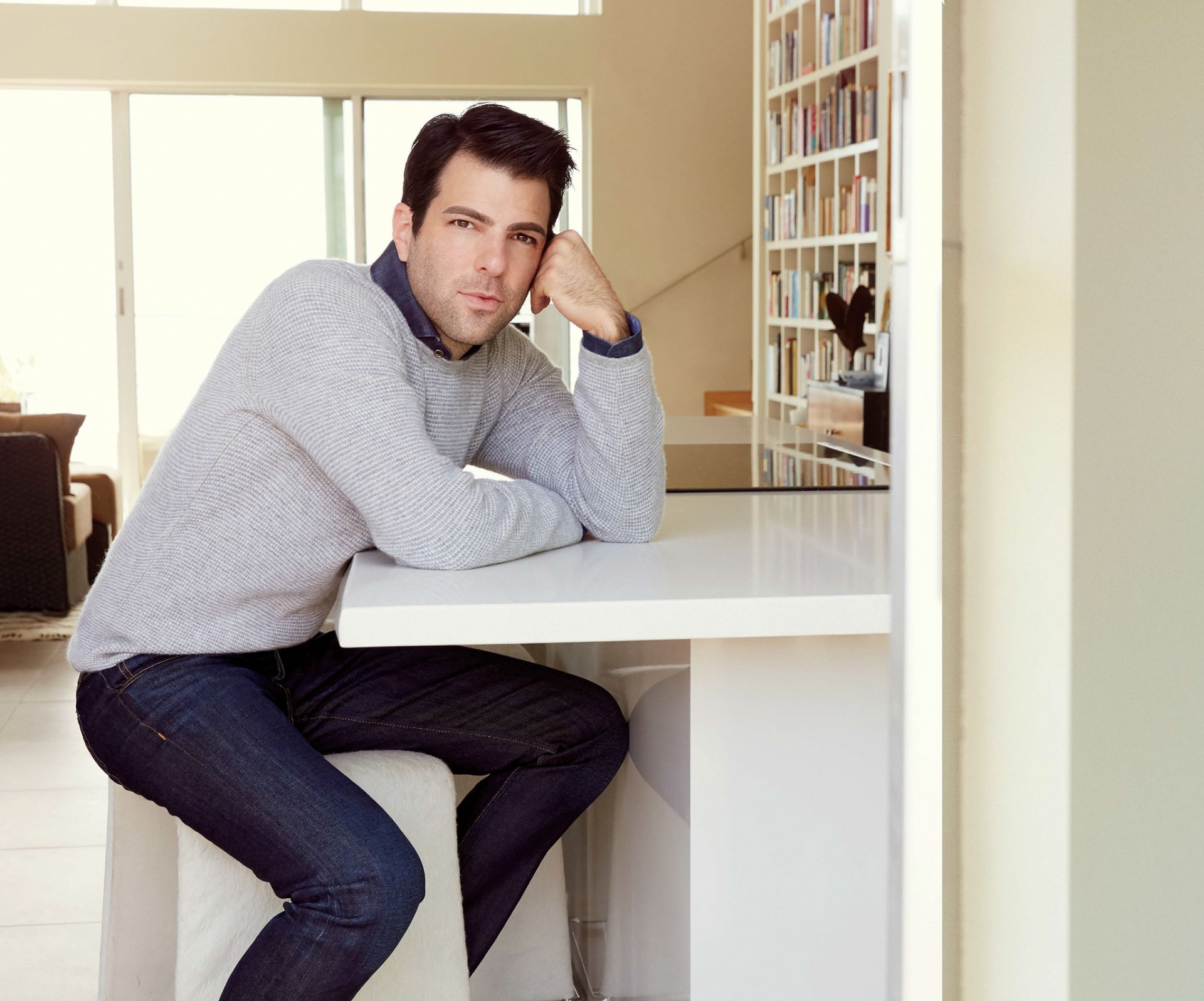 zachary quinto actor sitting at the table sweater jeans photoshoot robert ascroft magazine hamptons