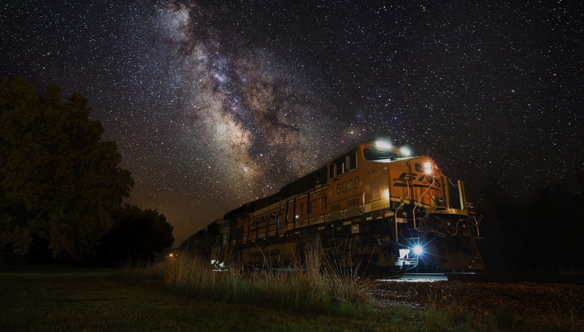 A night train is going, and the Milky Way is in the sky