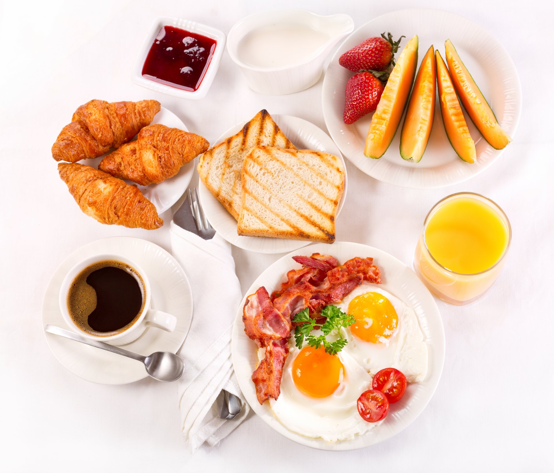 breakfast coffee cup croissant croissants tray strawberry juice jam cream toast fruits eggs bacon