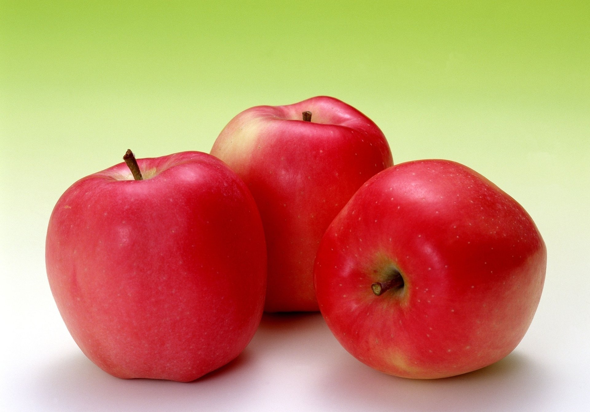 Red juicy apples as background wallpaper