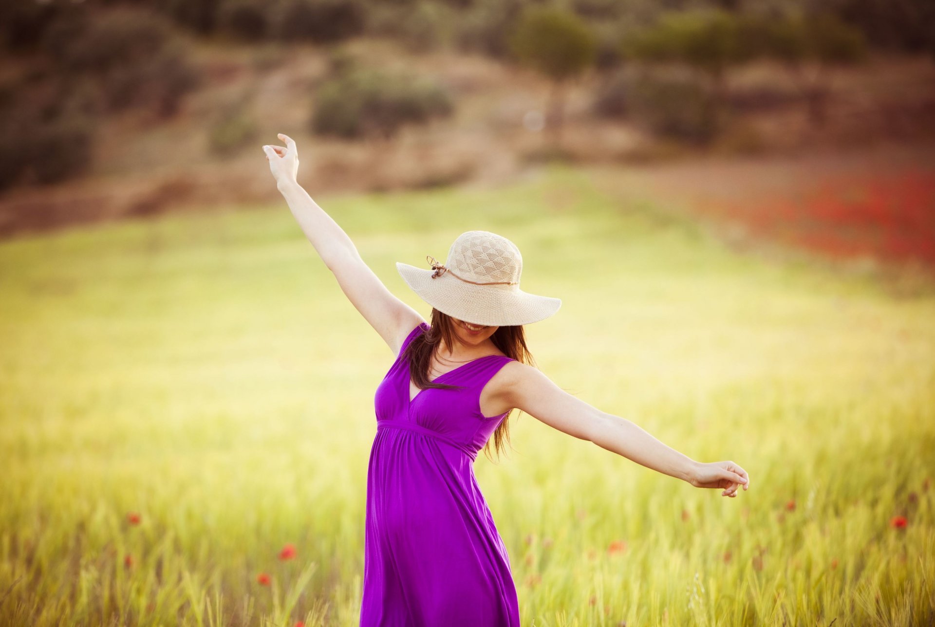 mood girl brunette a woman hands purple dress hat smile happiness positive freedom relax the field flower flowers tree foliage leaves blur background wallpaper widescreen full screen hd wallpapers