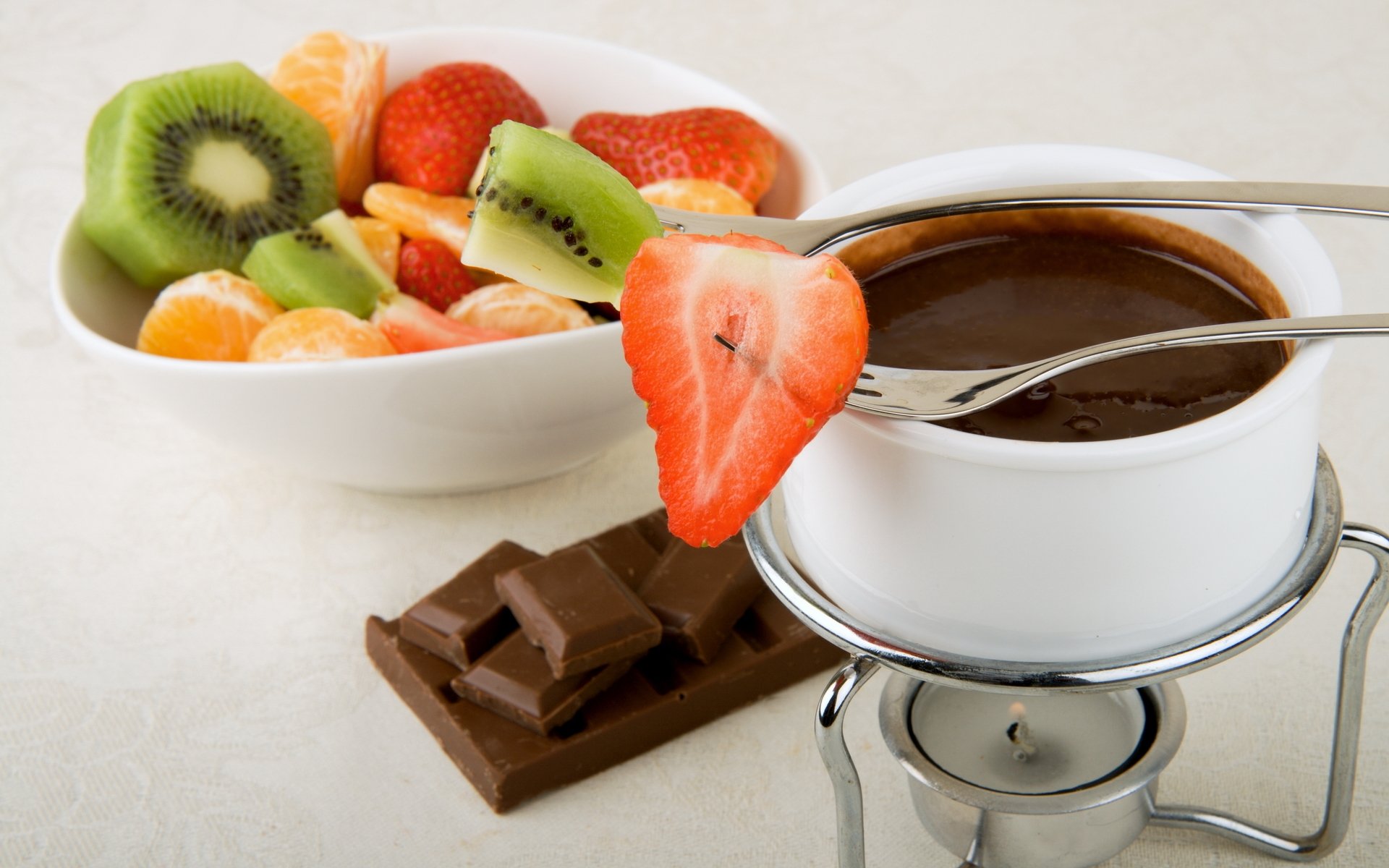 food sweet hot chocolate chocolate fruit . strawberry kiwi mandarins cup fork segments