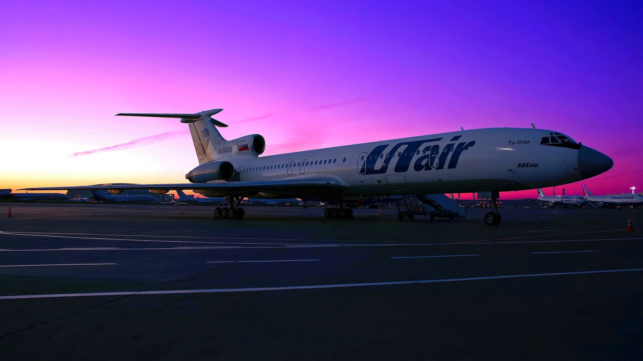 utair tupolev tu- 154 plane passenger wing engine chassis parking the platform airport sky sunset aircraft ramp