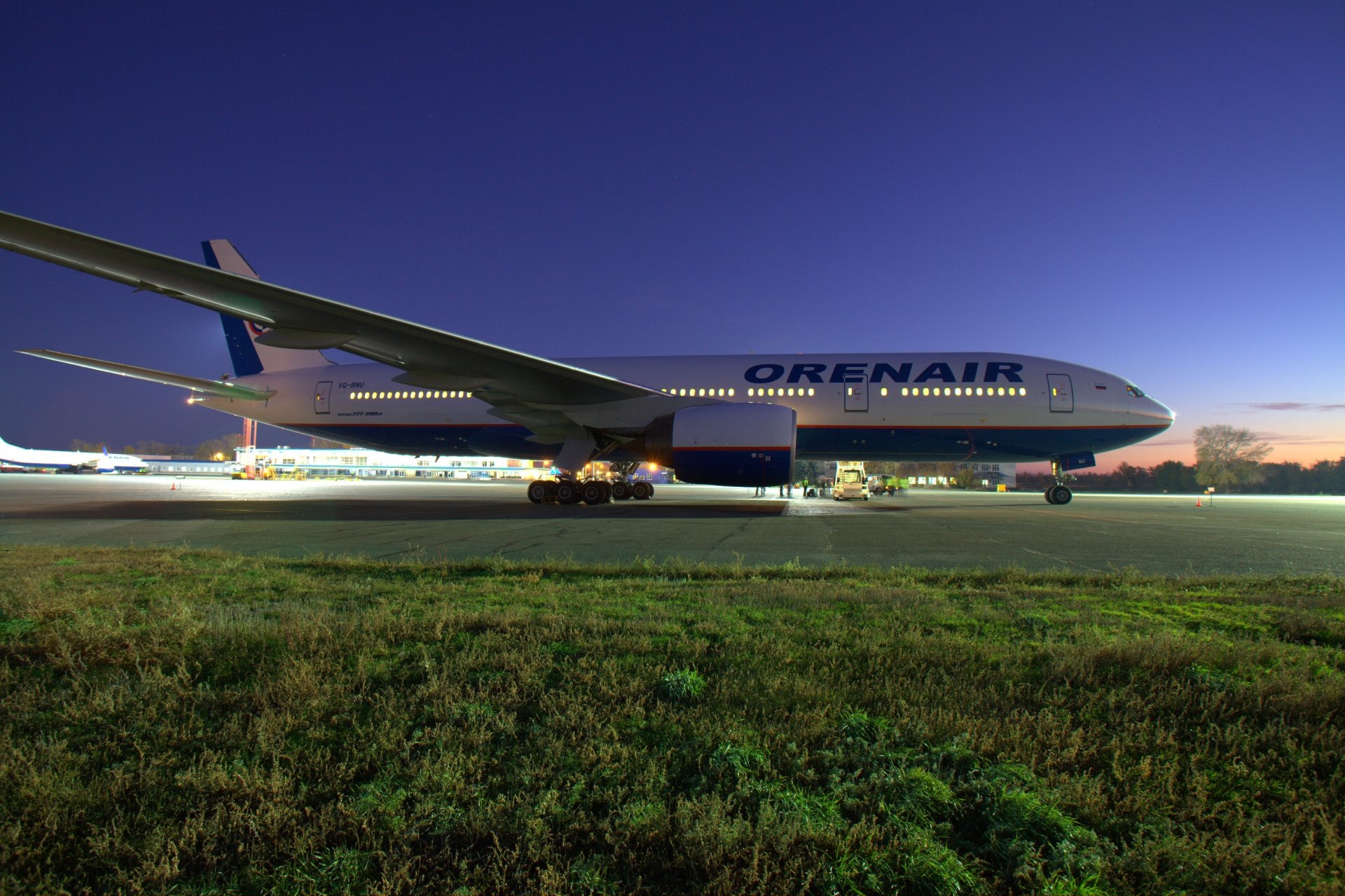 boeing 777 orenair plane wing airliner passenger sky sunrise airport lights night airplane