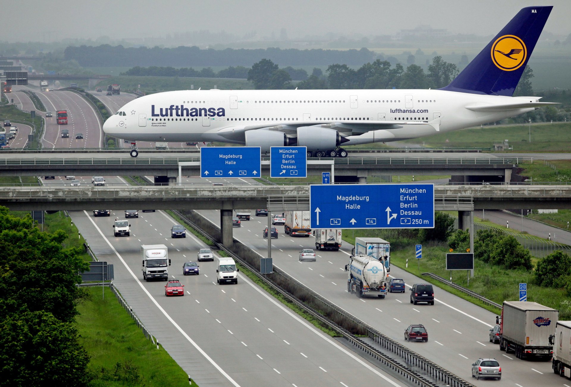 lufthansa airbus a380 passenger airliner plane town road bridge autobahn machinery airplane city highway cars