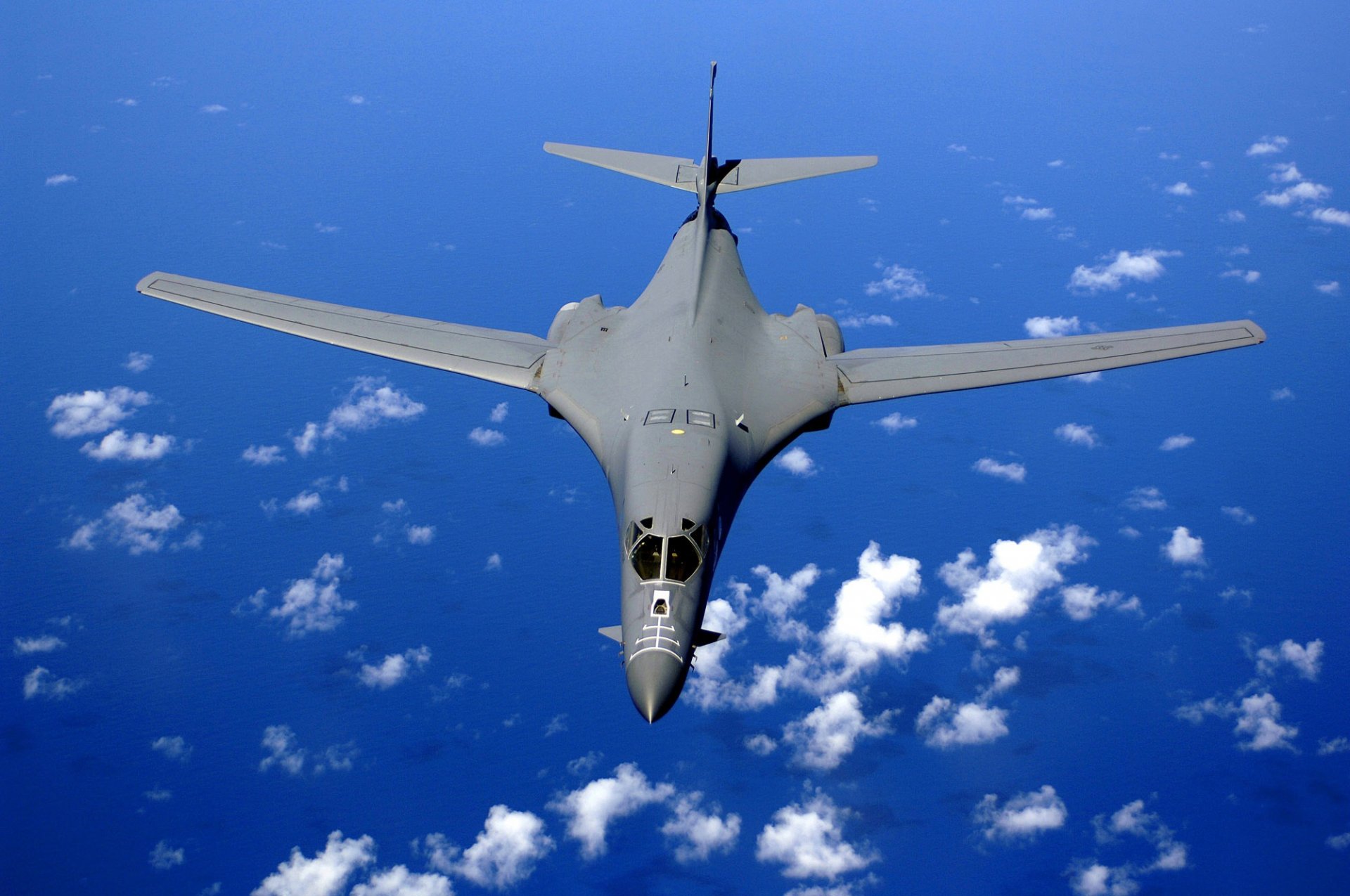 supersonic strategic bomber rockwell b-1 lancer plane flight height clouds sky ocean water