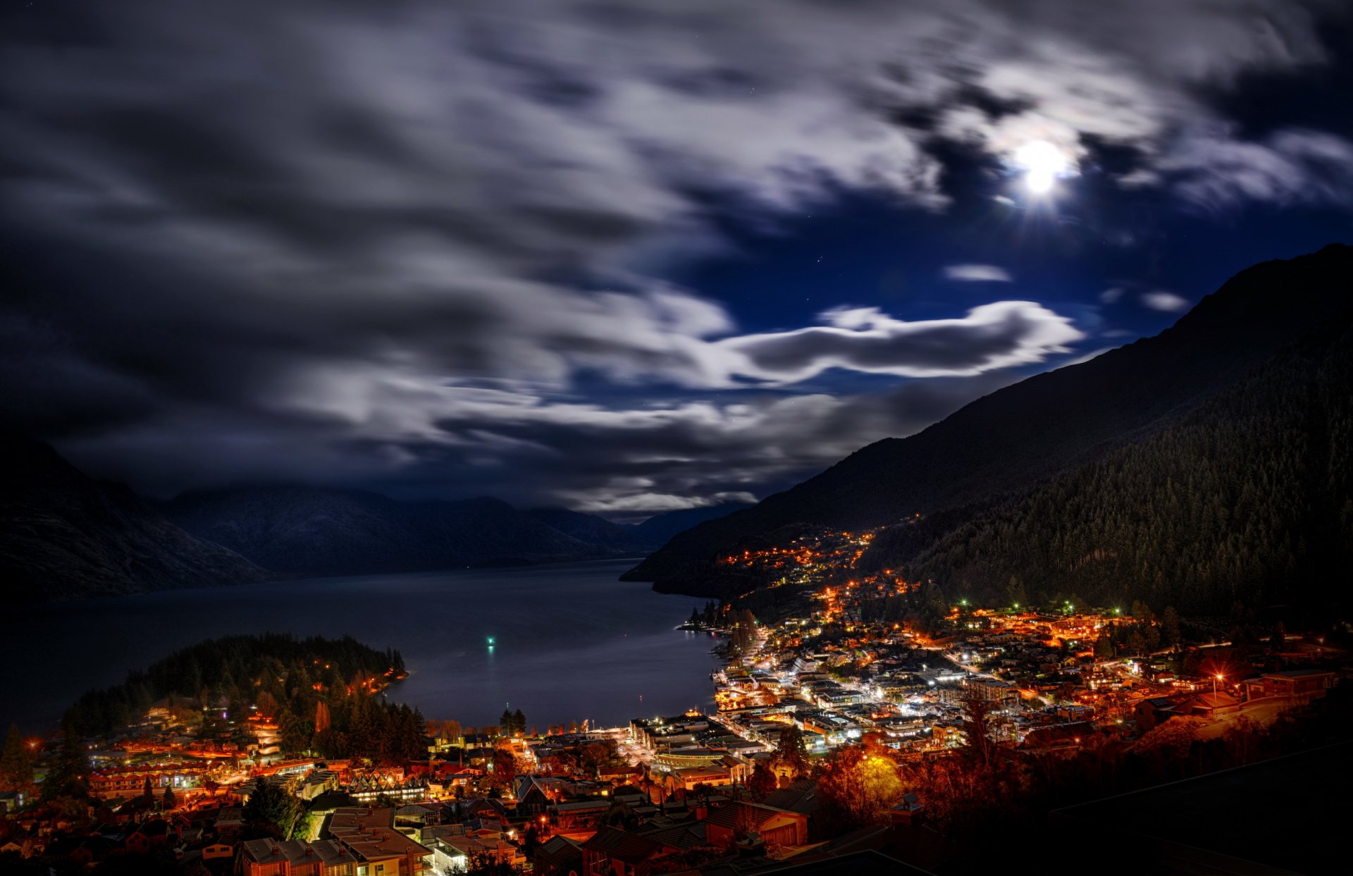 new zealand queenstown night plays clouds gordes town lake bay house lights streets forest tree landscape view.
