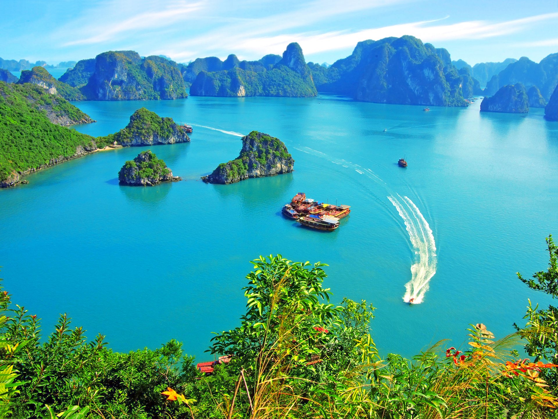 vietnam halong bay rock islands vegetation pleasure boats yacht junks sky clouds