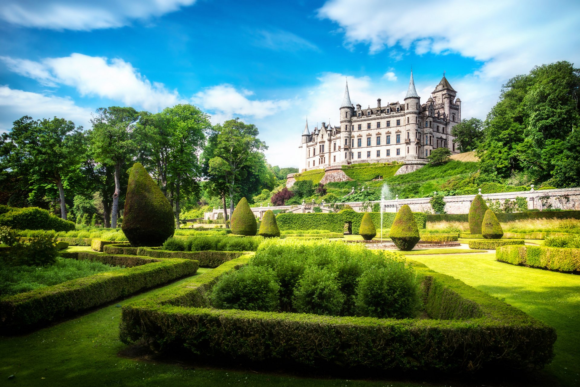 dunrobin castle sutherland scotland alba great britain united kingdom castle park sun light sky clouds green grass turf bush tree fountain nature landscape