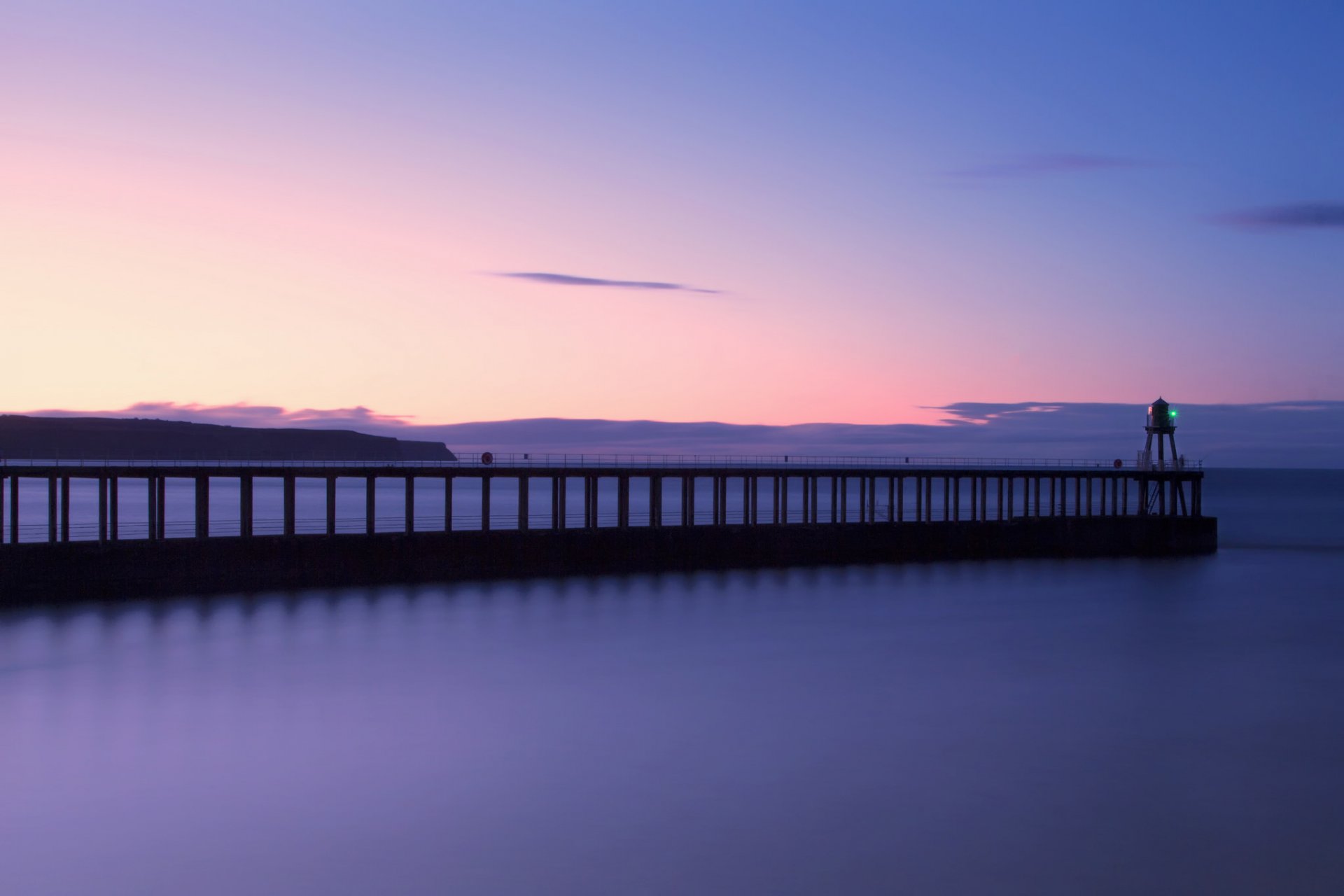 united kingdom england north yorkshire north sea beach pier lighthouse night sunset sky clouds