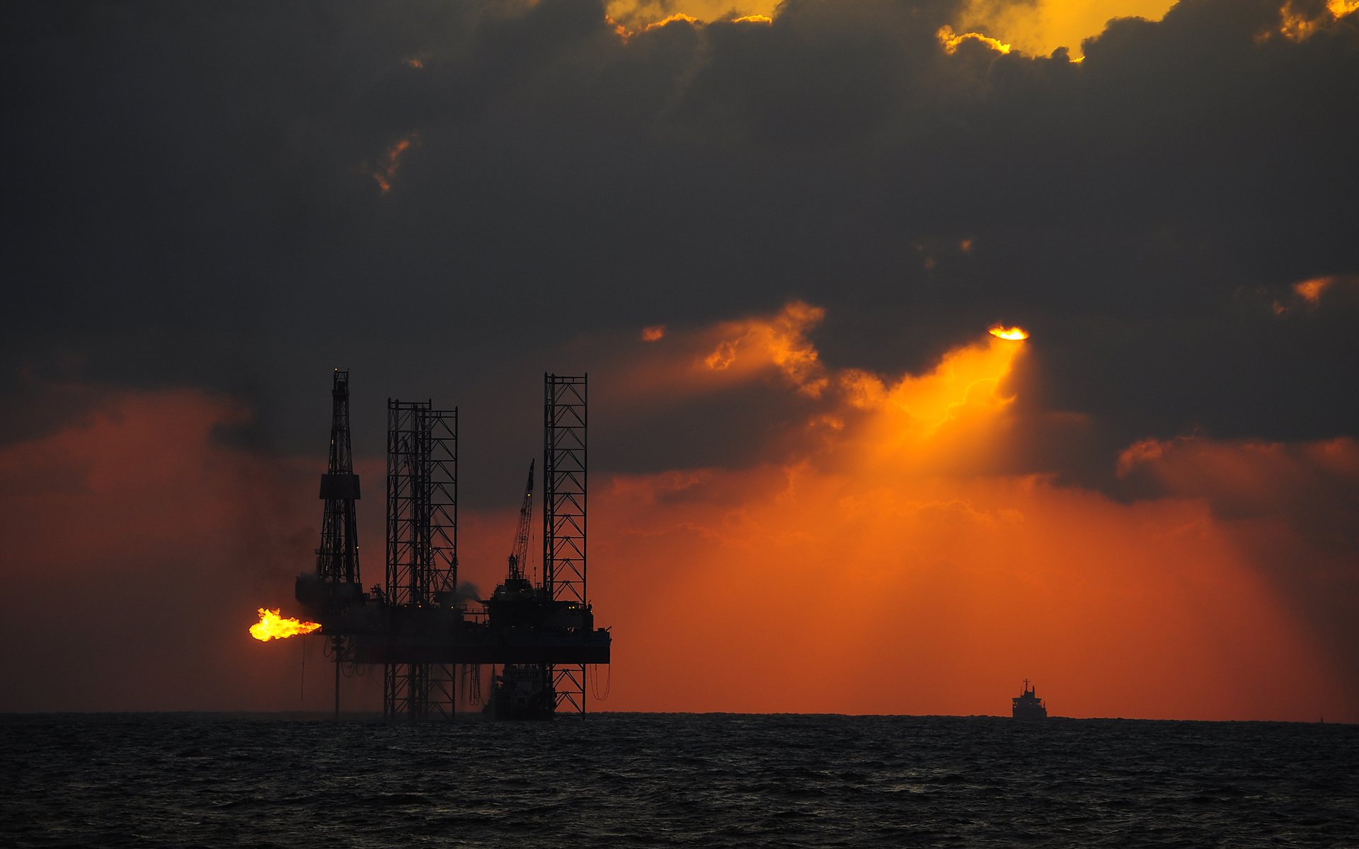 sea sun oil platforms ship tanker sunset silhouettes